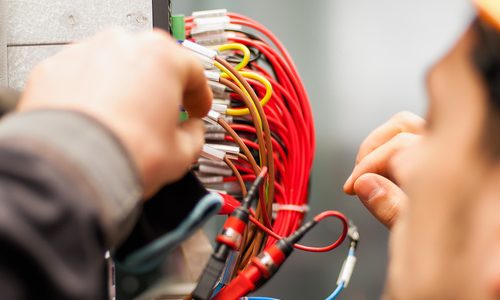 Electrician engineer tests electrical installations on relay protection system
